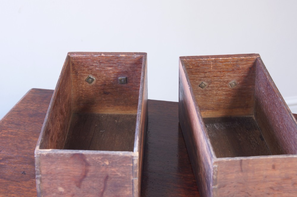 An 18th-century oak lowboy side table featuring cabriole legs, multiple drawers with brass swing handles, and an arched apron detail. View VI