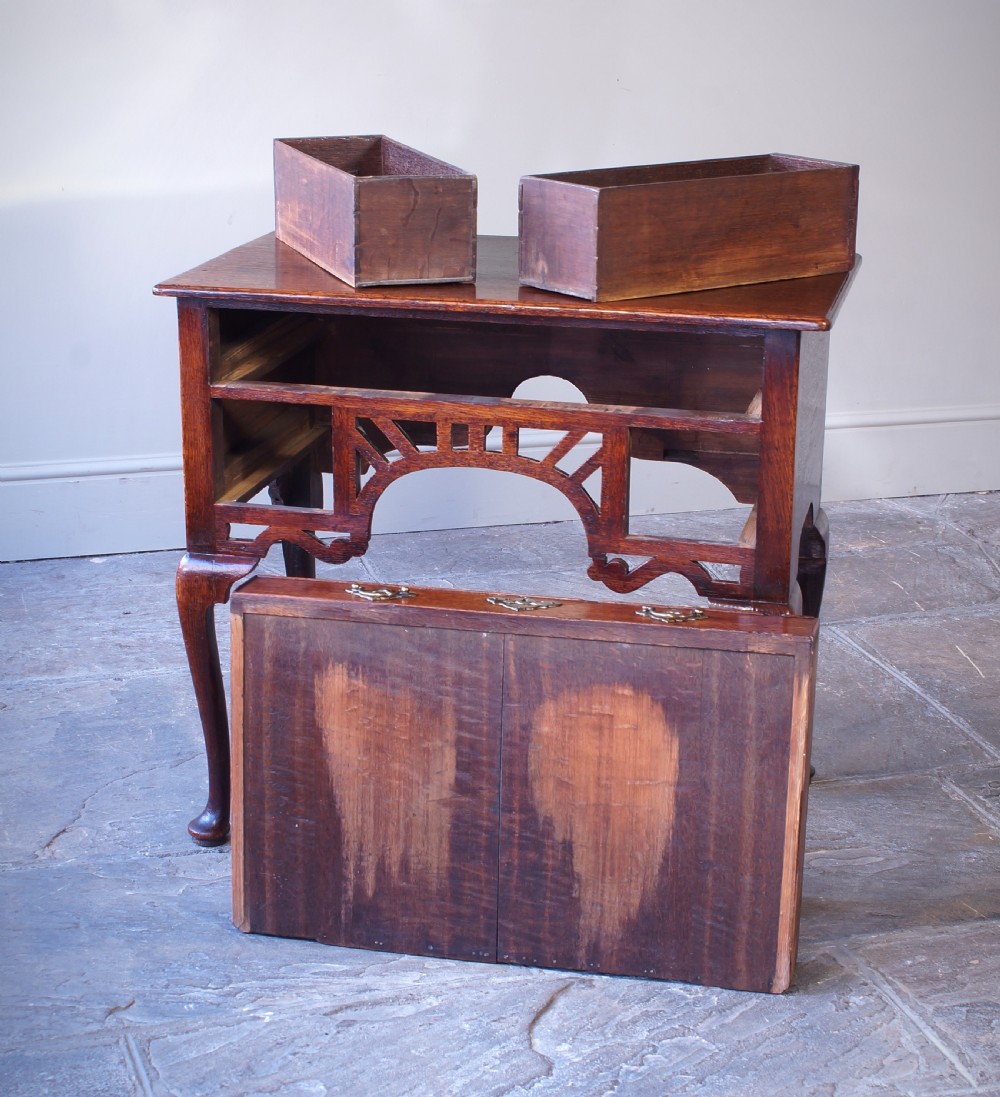 An 18th-century oak lowboy side table featuring cabriole legs, multiple drawers with brass swing handles, and an arched apron detail. View VII