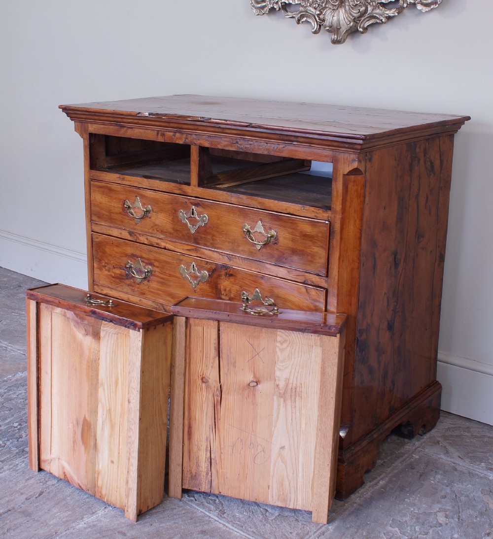 An 18th-century Georgian chest of drawers crafted from highly figured warm honey-toned yew wood with two short drawers over three long drawers and brass batwing handles. View III