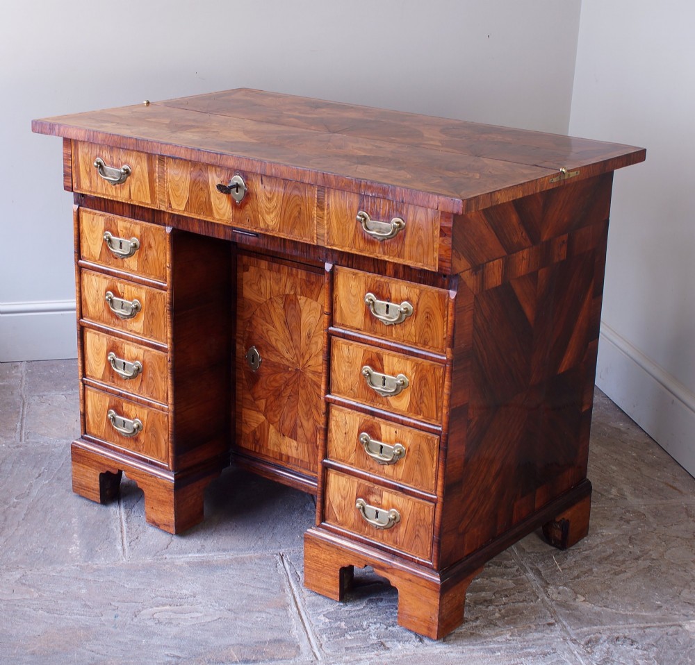 A William and Mary Kingwood oyster veneered kneehole secretaire desk