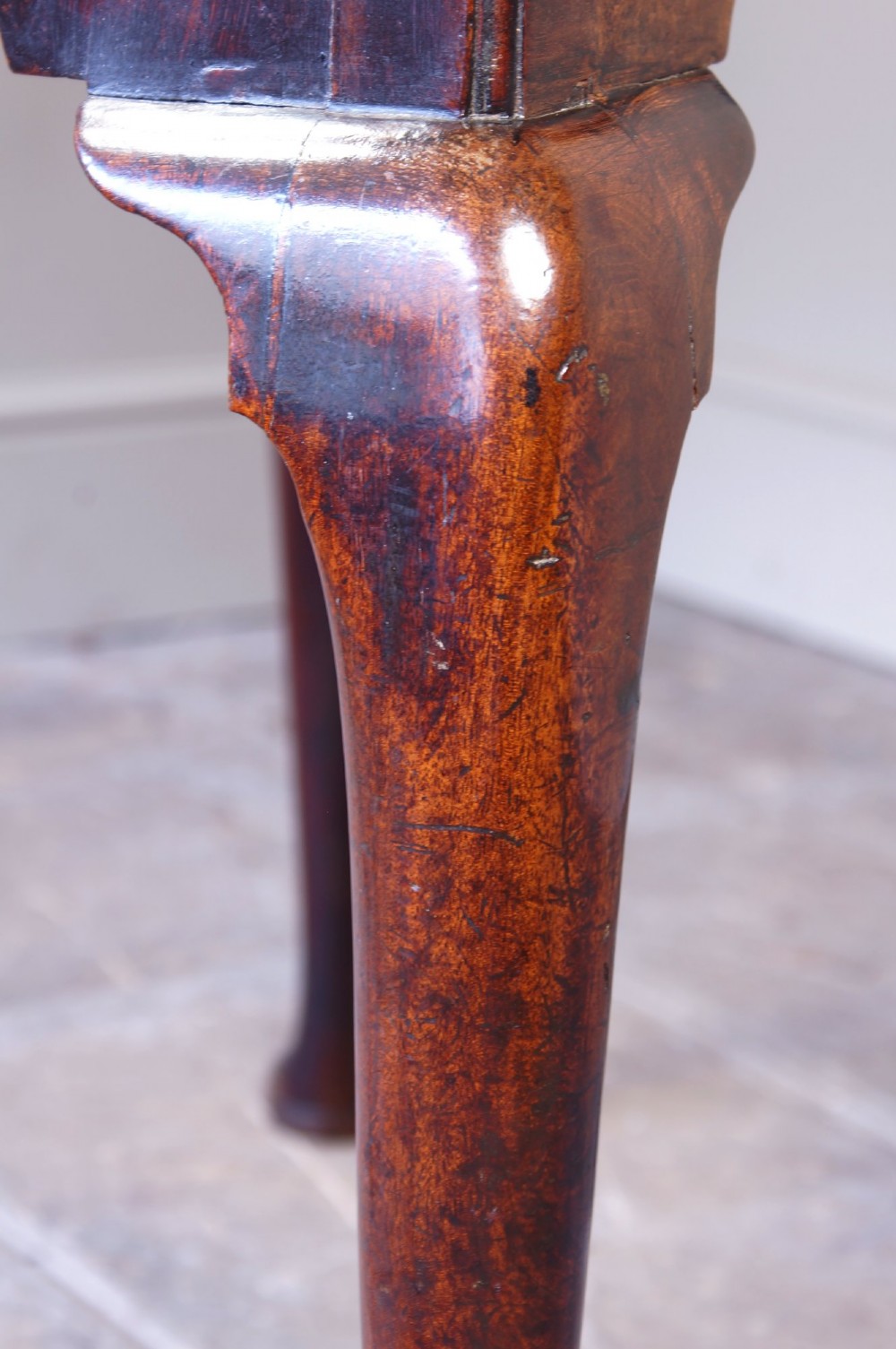 A mid-18th century George II mahogany lowboy featuring three drawers with brass handles, a shaped apron, and four cabriole legs ending in pad feet. View XIII