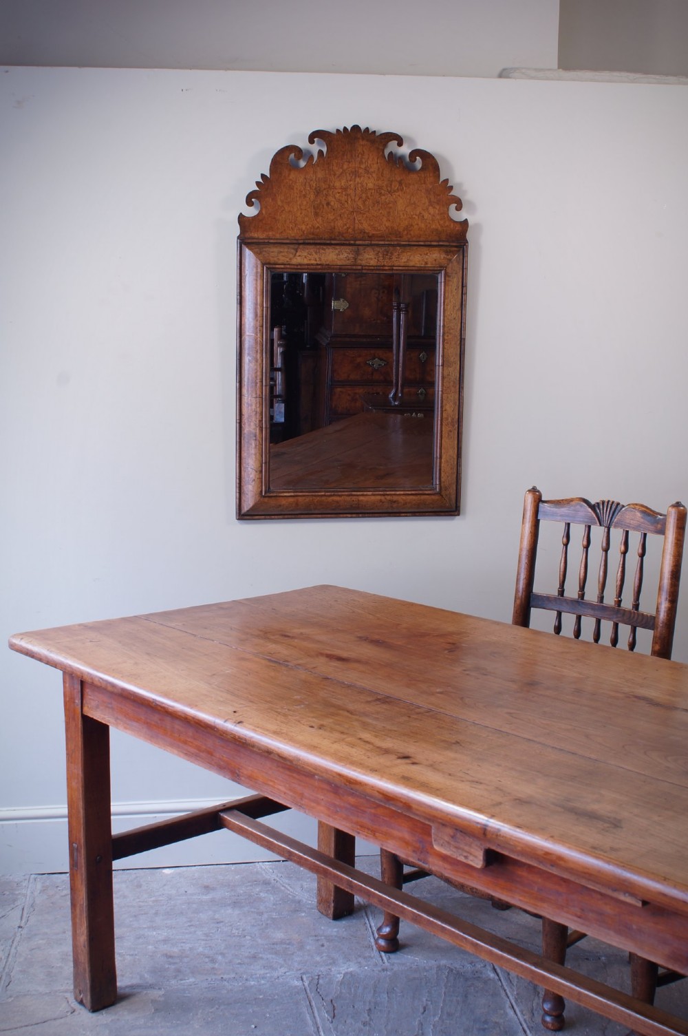 A rectangular William and Mary style wall mirror framed in burr walnut veneer with a cushion moulding and an intricately shaped fretwork crest. View IV