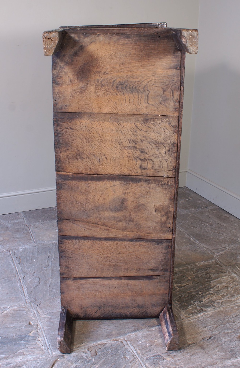 A 17th-century dark oak coffer with three carved floral panels, an iron lock plate, and a dated inscription reading FH 1683 along the front rail. View VIII