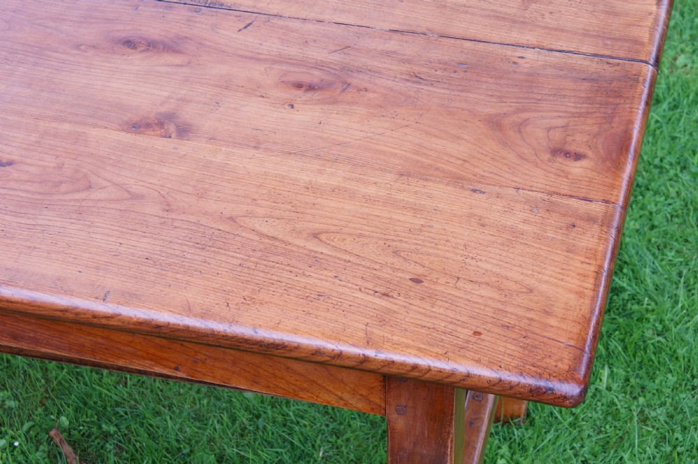A rectangular 19th-century French cherry wood dining table featuring a plank top, straight legs, and lower H-stretchers. View V
