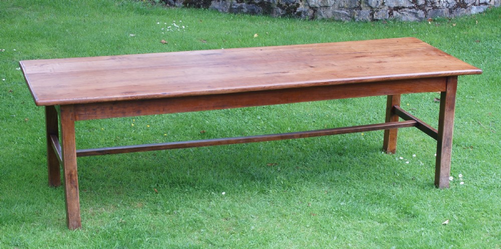 A rectangular 19th-century French cherry wood dining table featuring a plank top, straight legs, and lower H-stretchers. View IX