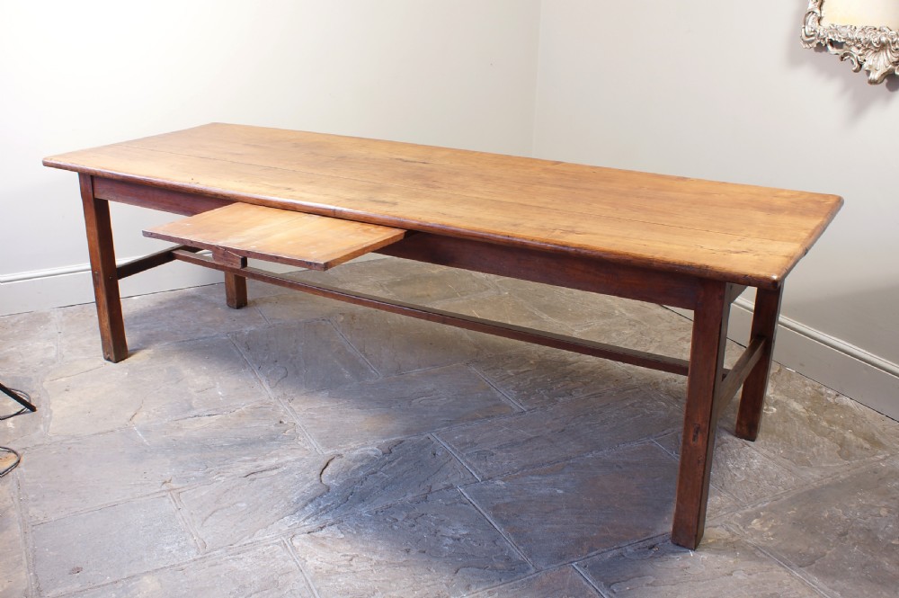 A rectangular 19th-century French cherry wood dining table featuring a plank top, straight legs, and lower H-stretchers. View XI