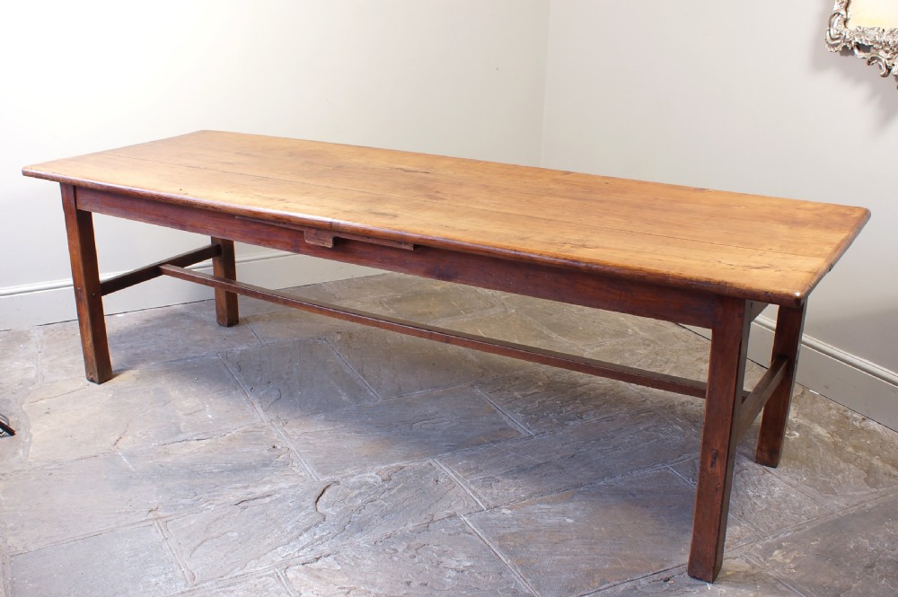 A rectangular 19th-century French cherry wood dining table featuring a plank top, straight legs, and lower H-stretchers. View XII