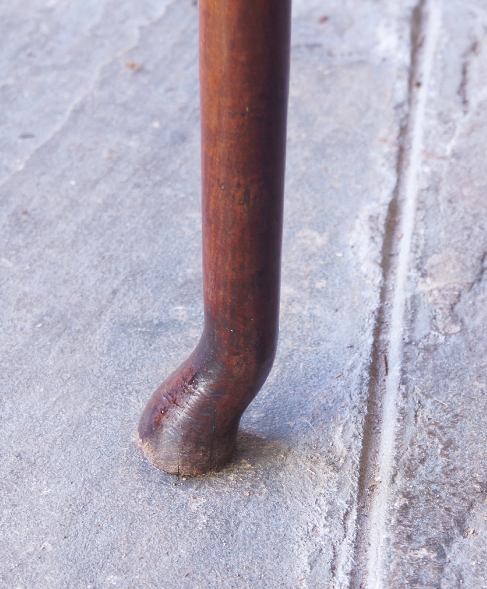 An early 18th-century fruitwood centre table featuring a rectangular plank top, a scalloped apron, and slender turned legs ending in pad feet. View VIII