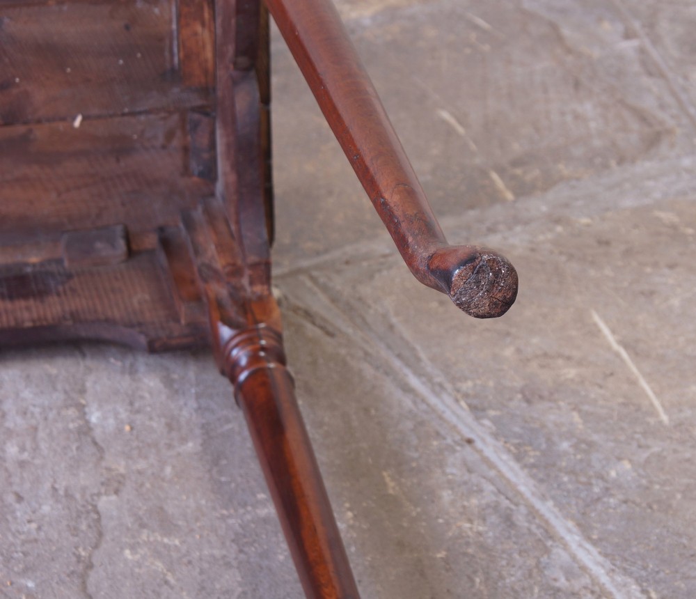An early 18th-century fruitwood centre table featuring a rectangular plank top, a scalloped apron, and slender turned legs ending in pad feet. View XV