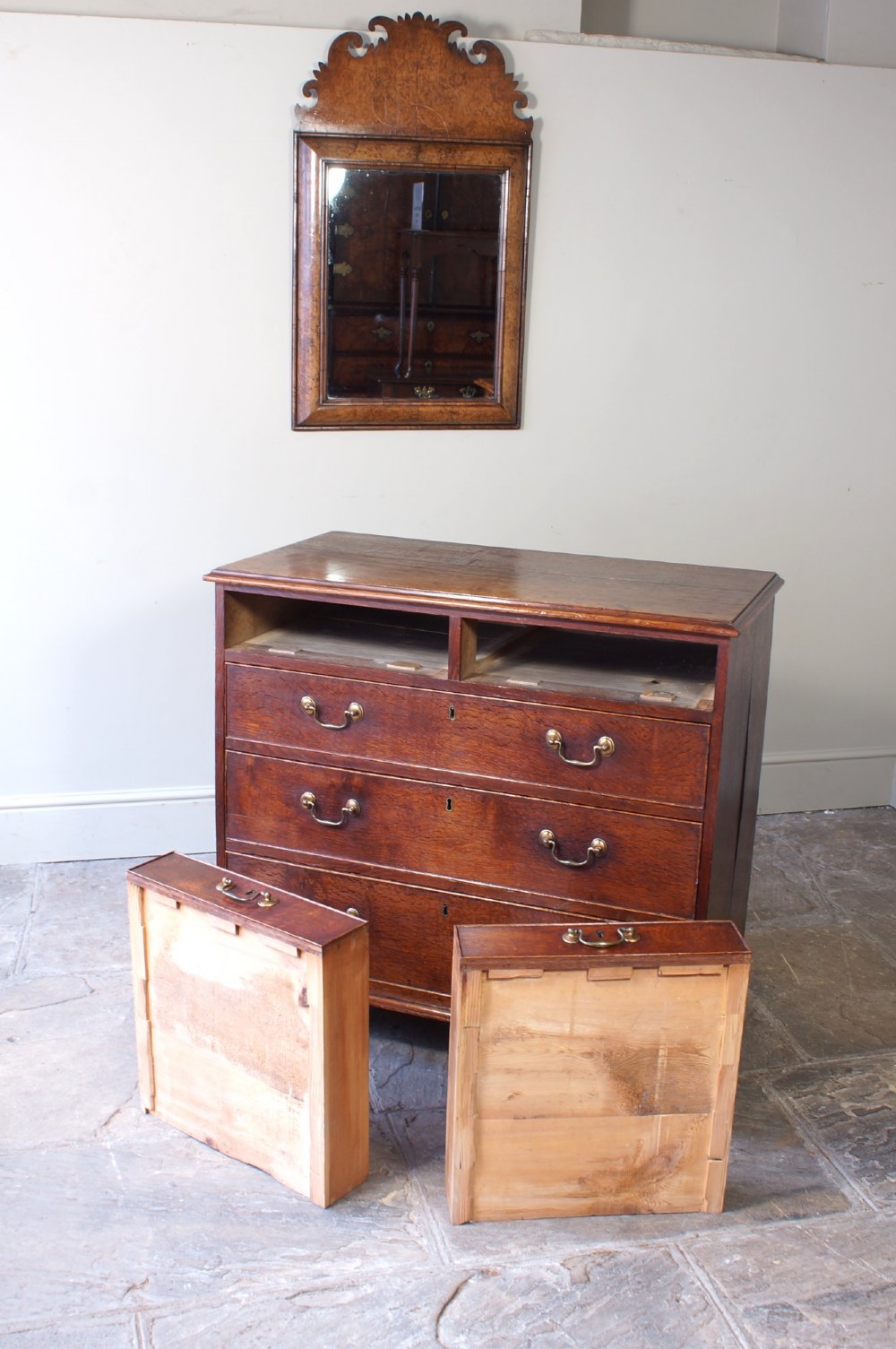 A Georgian oak chest of drawers featuring two short over three long graduated drawers with brass swan-neck handles and bracket feet. View VII