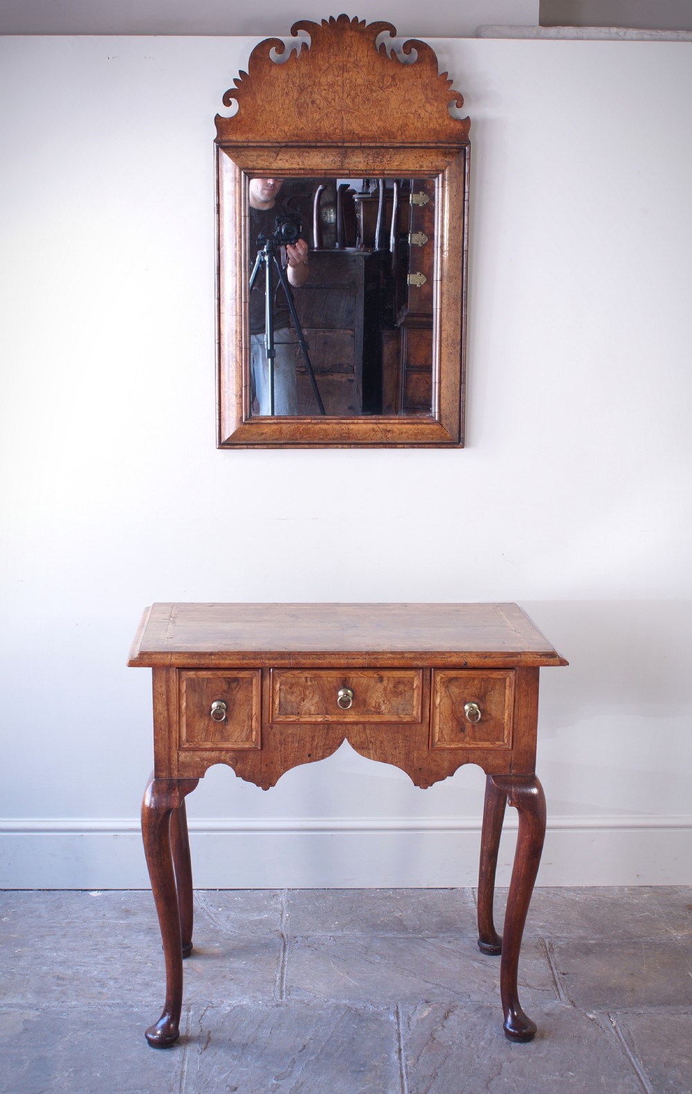 An early 18th-century walnut lowboy table with three drawers, brass ring pull handles, a scalloped apron, and cabriole legs ending in pad feet. View III