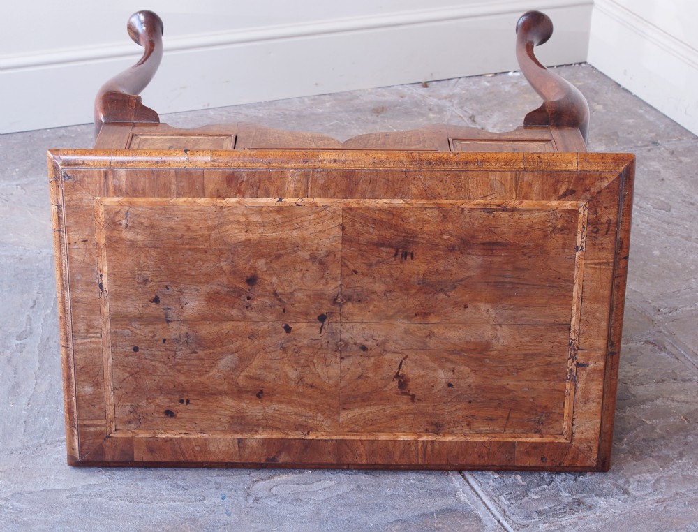 An early 18th-century walnut lowboy table with three drawers, brass ring pull handles, a scalloped apron, and cabriole legs ending in pad feet. View IV