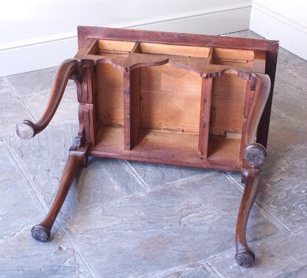 An early 18th-century walnut lowboy table with three drawers, brass ring pull handles, a scalloped apron, and cabriole legs ending in pad feet. View VIII