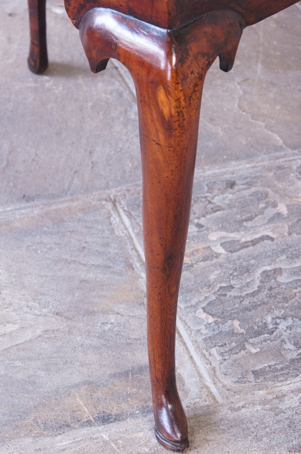 An 18th-century yew wood lowboy table featuring three drawers, a shaped scalloped apron, metal knob handles, and cabriole legs. View VII