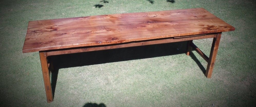 A long nineteenth-century elm farmhouse dining table with a thick plank top, straight legs, and side stretchers. View II