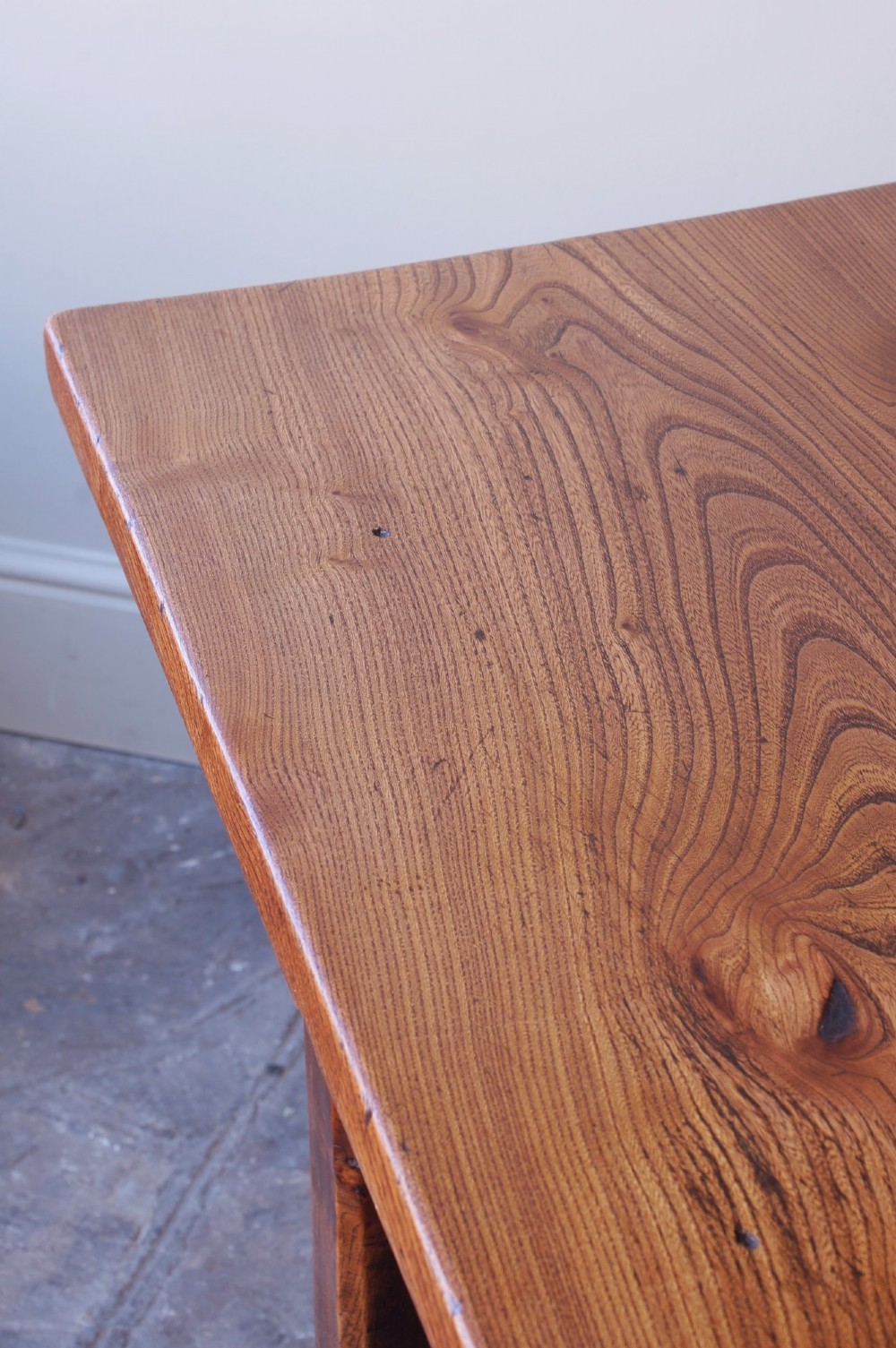 A long nineteenth-century elm farmhouse dining table with a thick plank top, straight legs, and side stretchers. View III