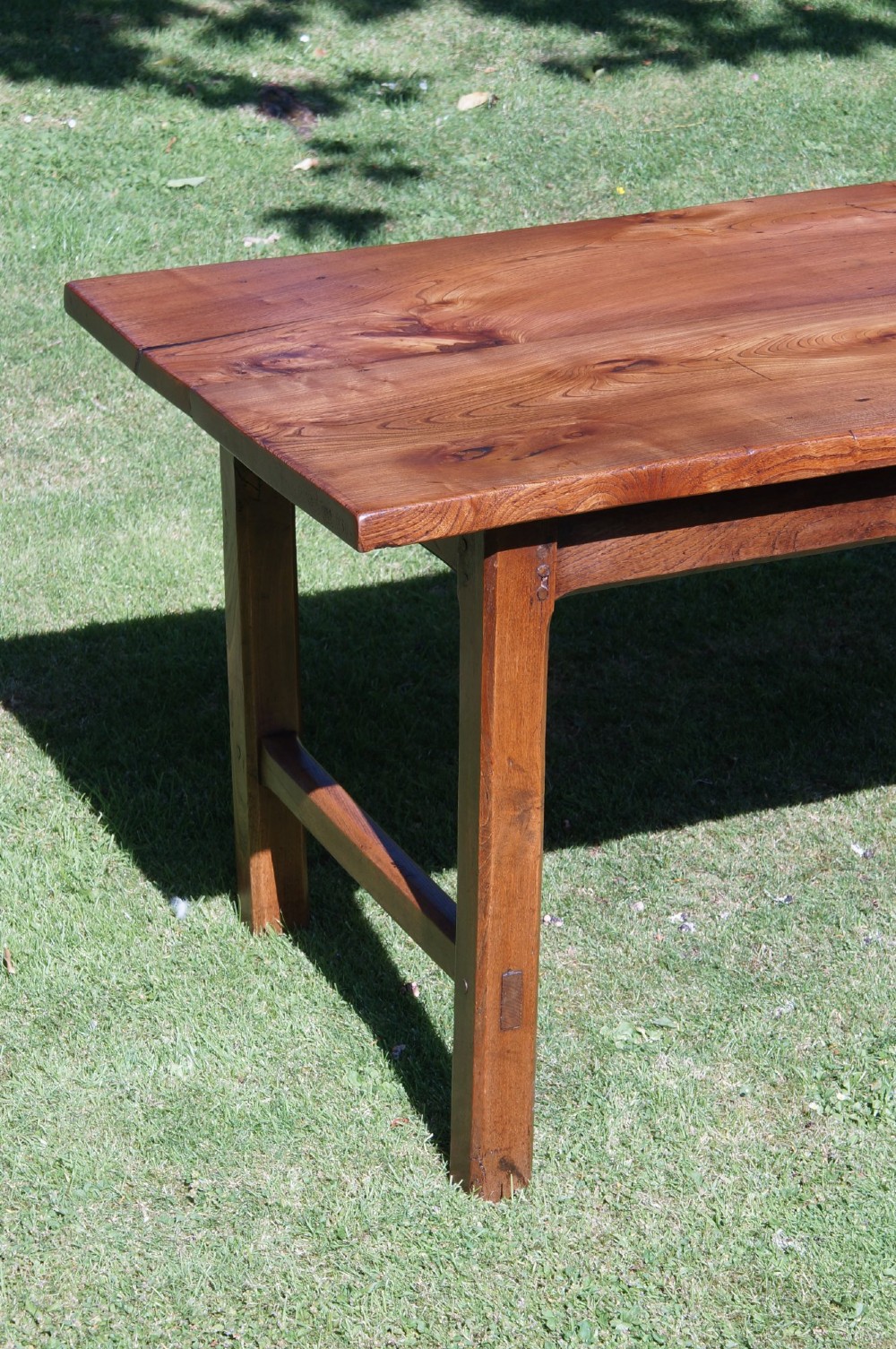 A long nineteenth-century elm farmhouse dining table with a thick plank top, straight legs, and side stretchers. View IV