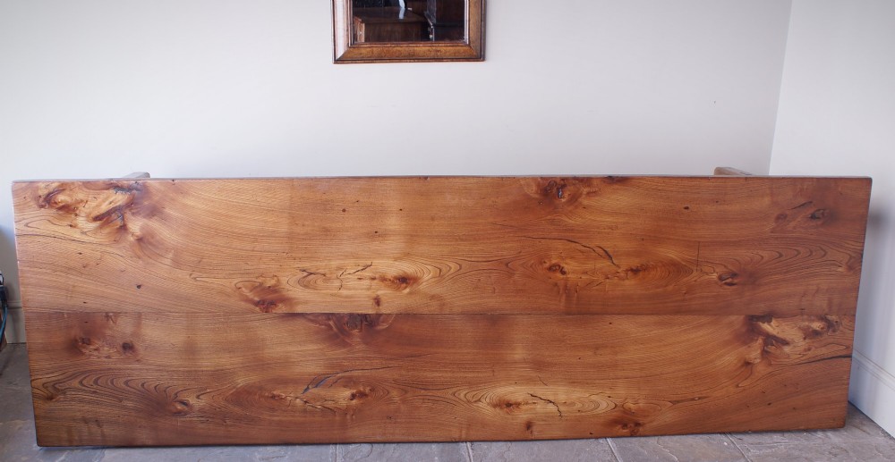 A long nineteenth-century elm farmhouse dining table with a thick plank top, straight legs, and side stretchers. View VI