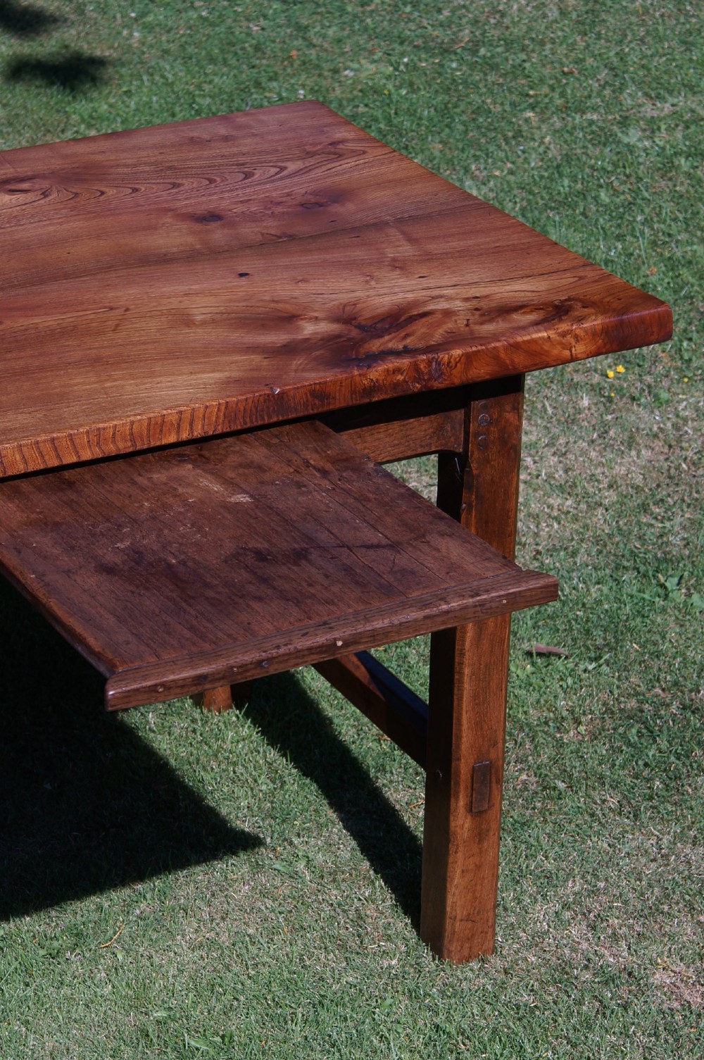 A long nineteenth-century elm farmhouse dining table with a thick plank top, straight legs, and side stretchers. View VII