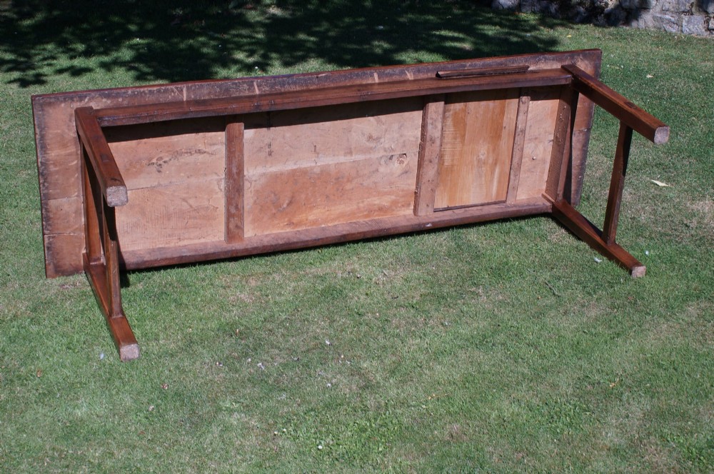 A long nineteenth-century elm farmhouse dining table with a thick plank top, straight legs, and side stretchers. View XI
