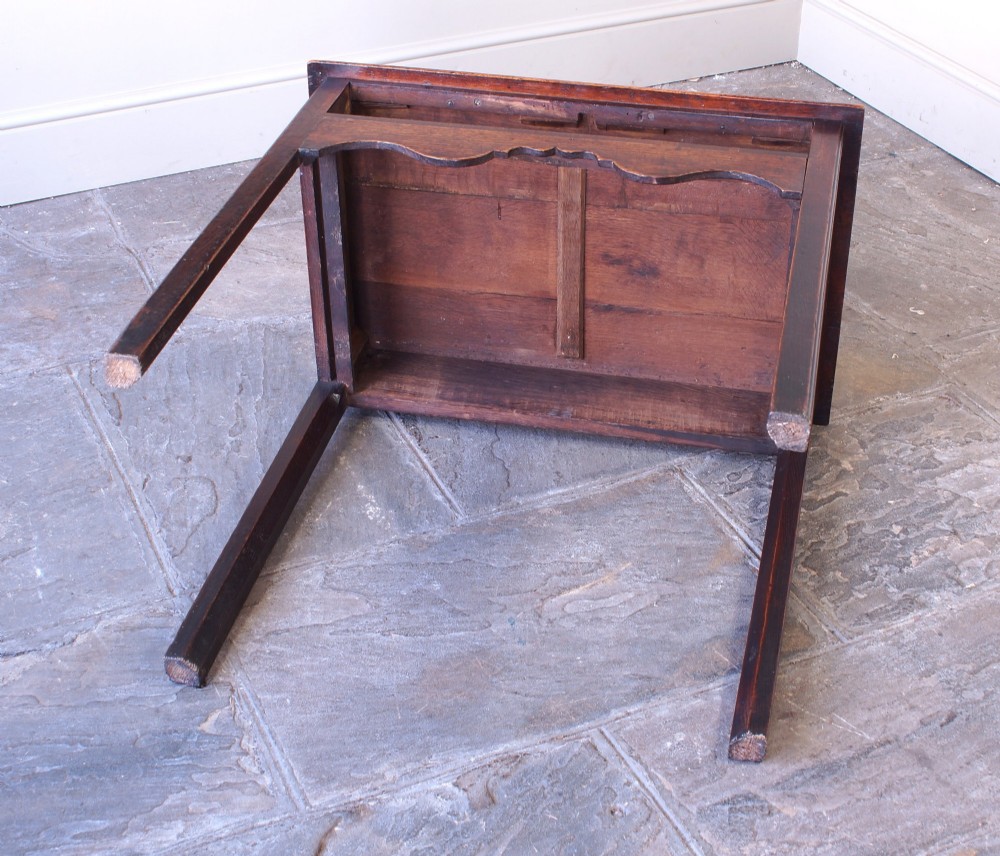 An 18th-century Georgian oak side table featuring a single drawer with decorative brass backplates and handles, set above a shaped apron and straight legs. View XIII