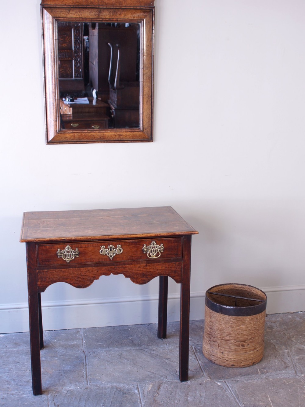 A cylindrical nineteenth-century French wooden grain measure with rustic iron banding, hand-riveted joints, and a central iron crossbar. View II