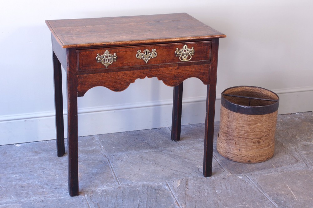 A cylindrical nineteenth-century French wooden grain measure with rustic iron banding, hand-riveted joints, and a central iron crossbar. View IV
