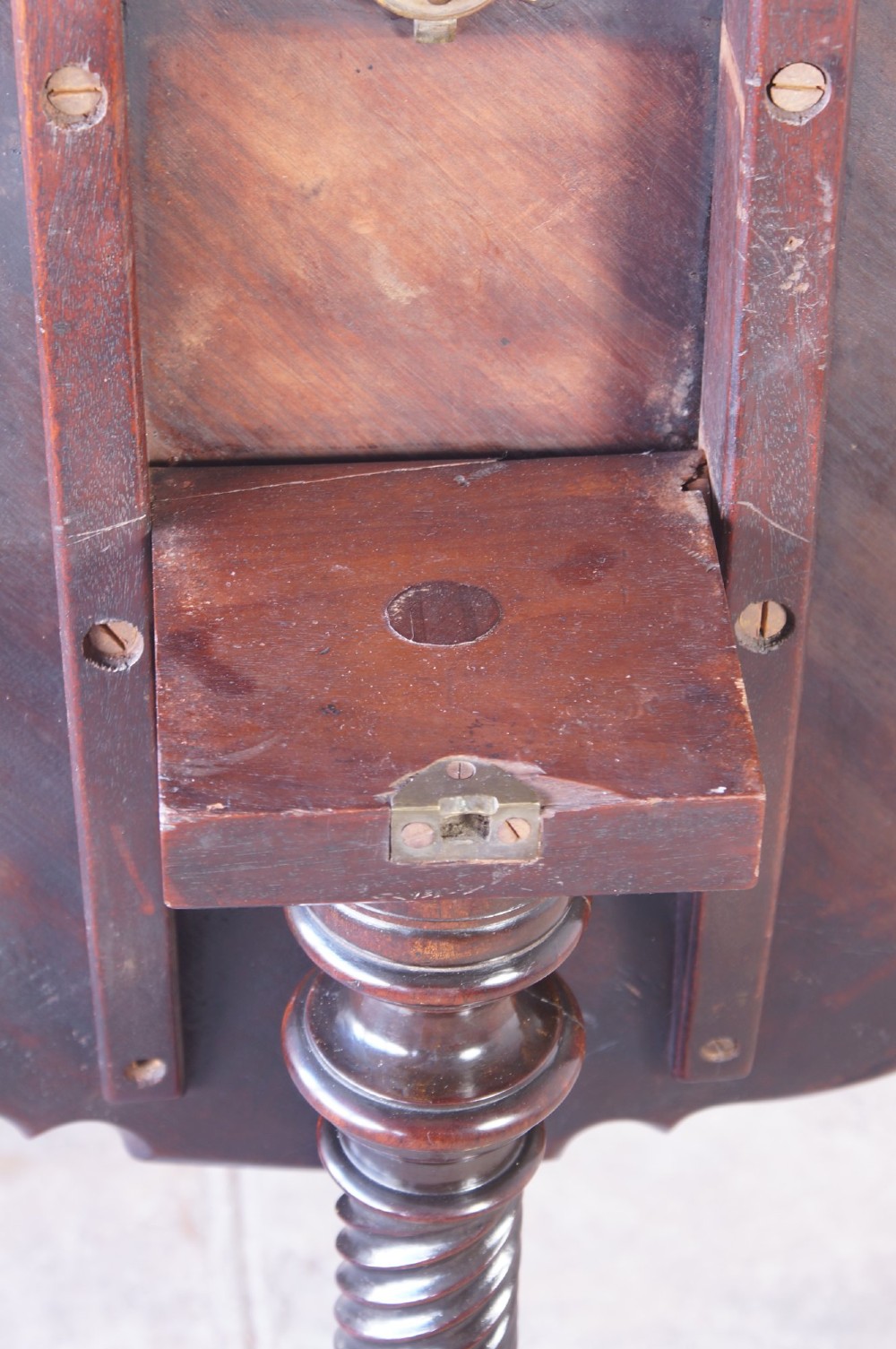An 18th-century George III mahogany tripod table with a scalloped piecrust tilt-top, turned spiral column standard, and carved cabriole legs. View IV