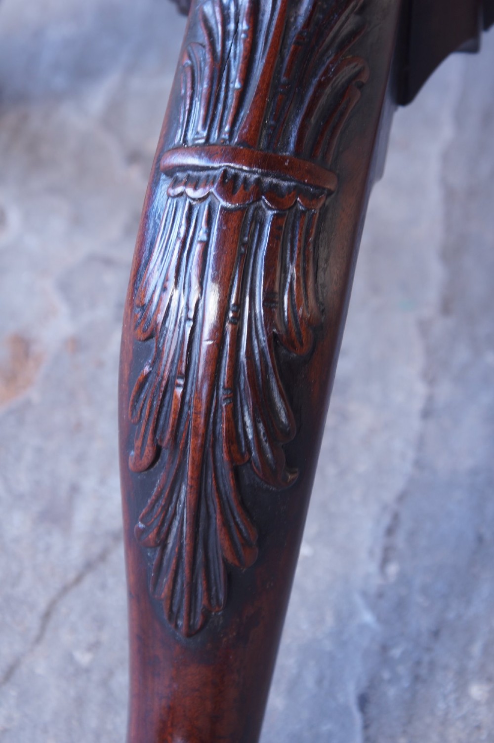 An 18th-century George III mahogany tripod table with a scalloped piecrust tilt-top, turned spiral column standard, and carved cabriole legs. View VI