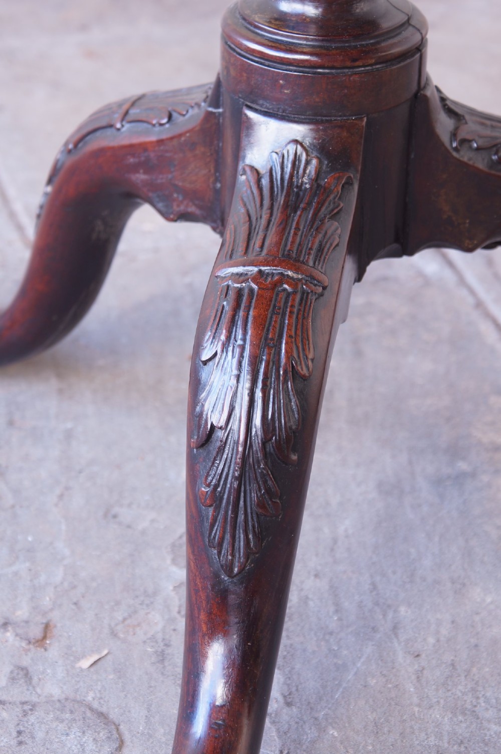 An 18th-century George III mahogany tripod table with a scalloped piecrust tilt-top, turned spiral column standard, and carved cabriole legs. View VIII