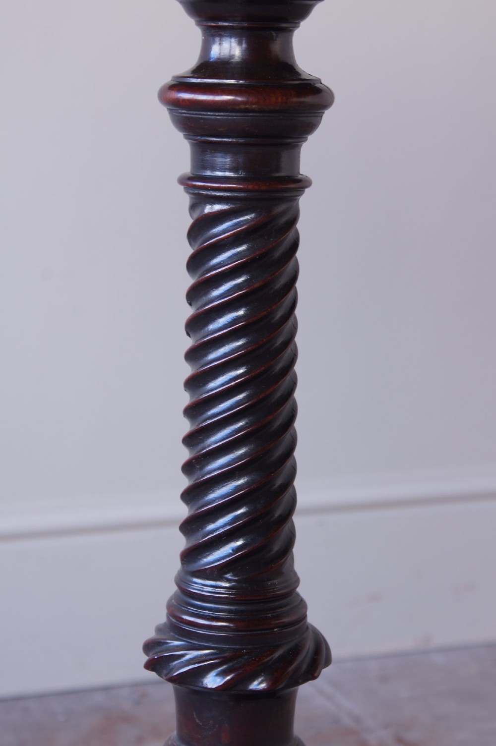 An 18th-century George III mahogany tripod table with a scalloped piecrust tilt-top, turned spiral column standard, and carved cabriole legs. View IX