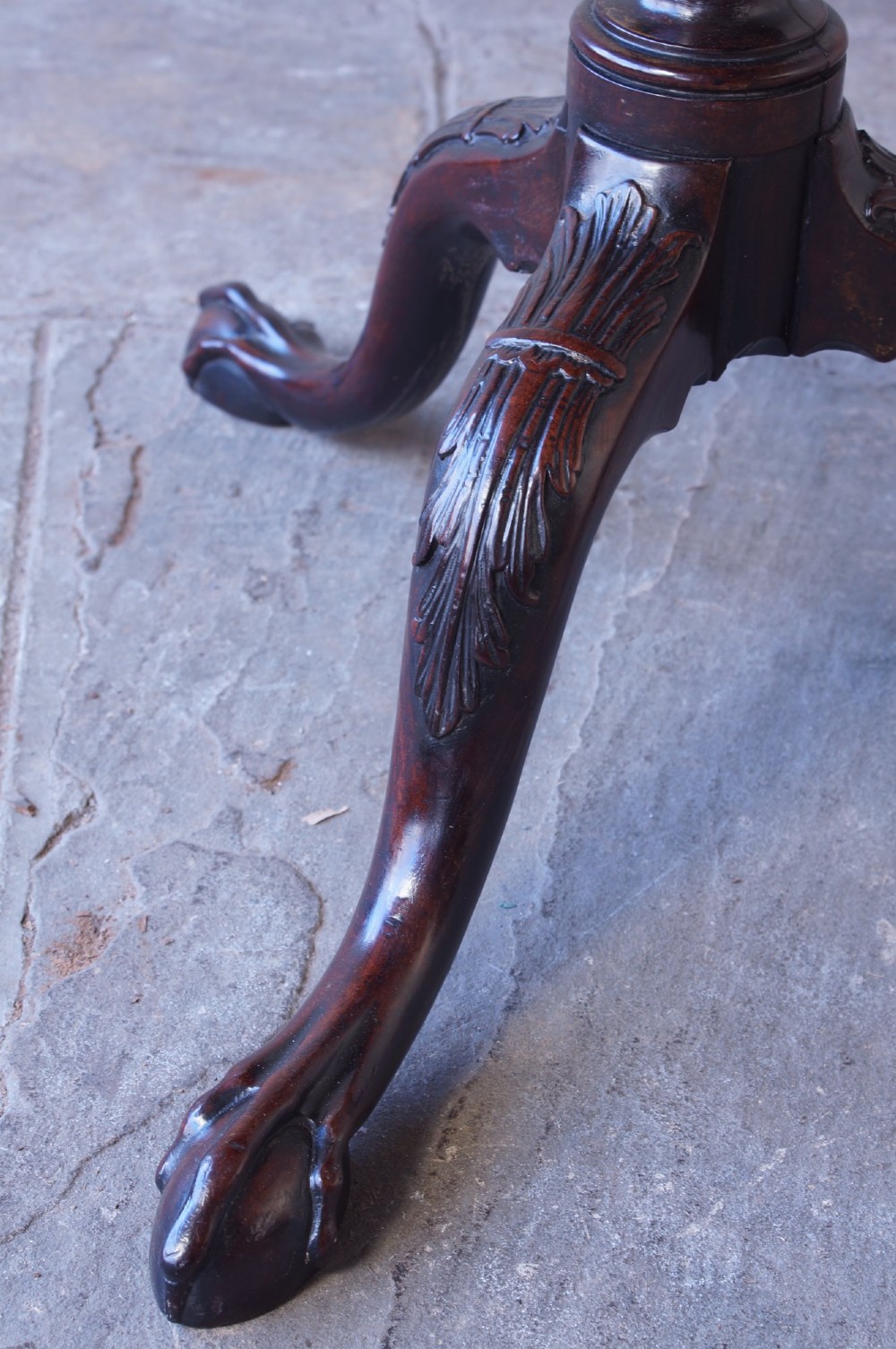 An 18th-century George III mahogany tripod table with a scalloped piecrust tilt-top, turned spiral column standard, and carved cabriole legs. View X