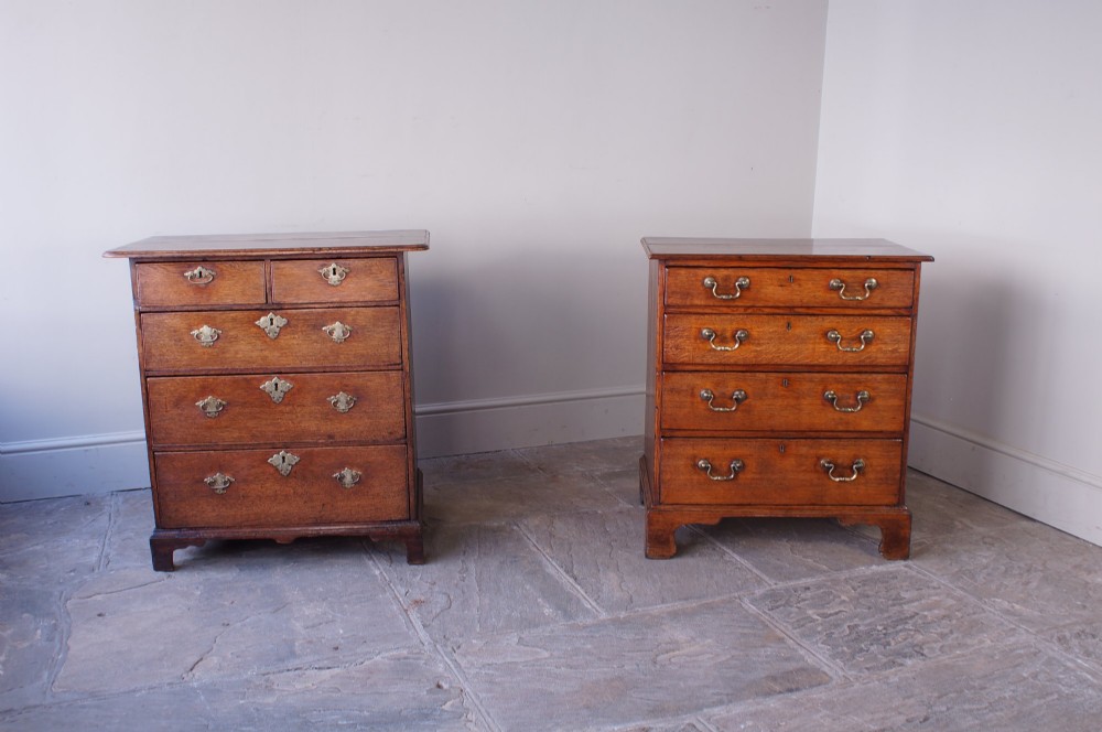 An early eighteenth-century oak chest of drawers featuring two short over three long drawers with brass drop handles and bracket feet. View II