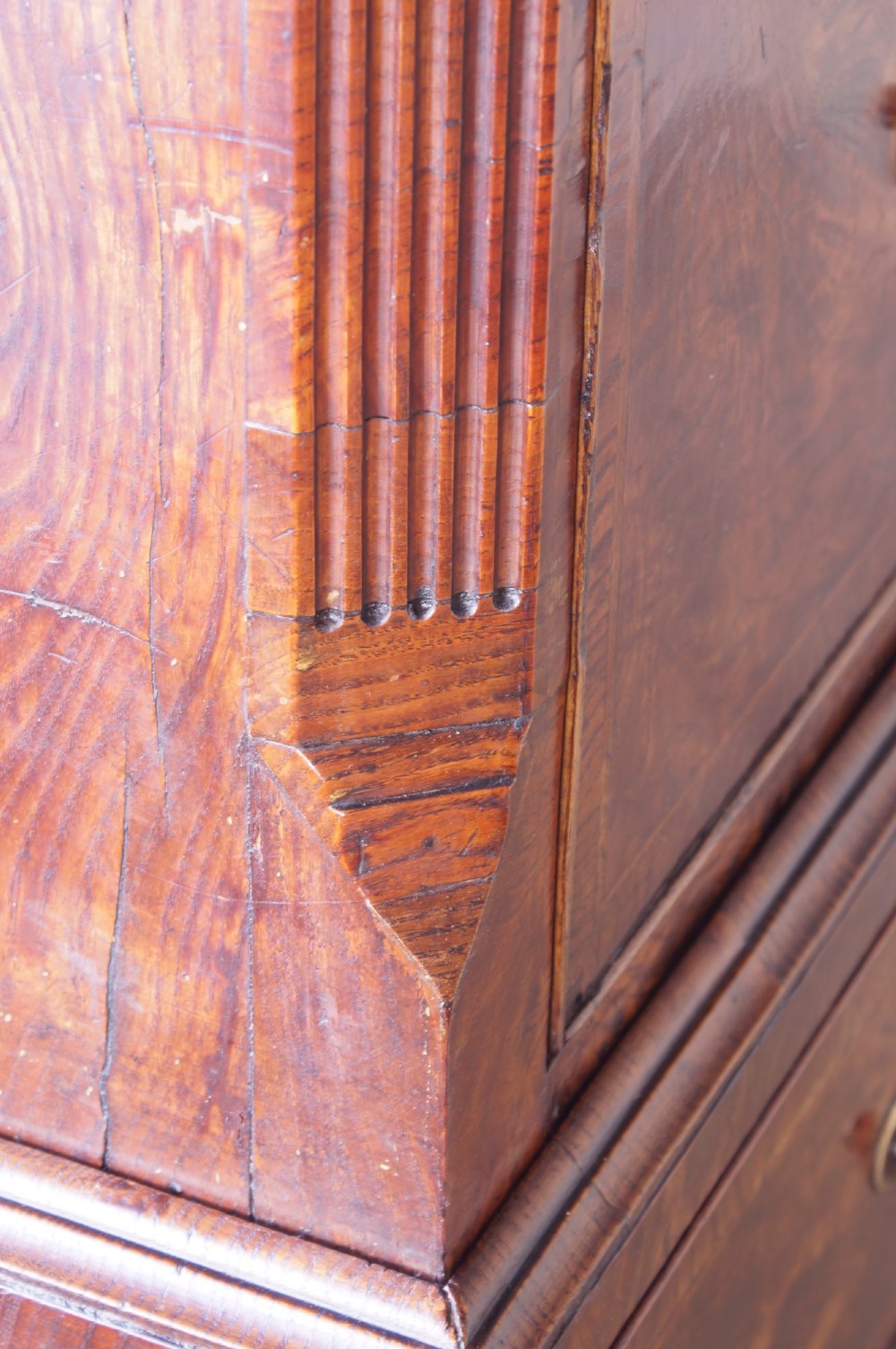 An 18th-century chest on chest crafted from figured ash featuring multiple graduated drawers with brass drop handles and bracket feet. View VIII