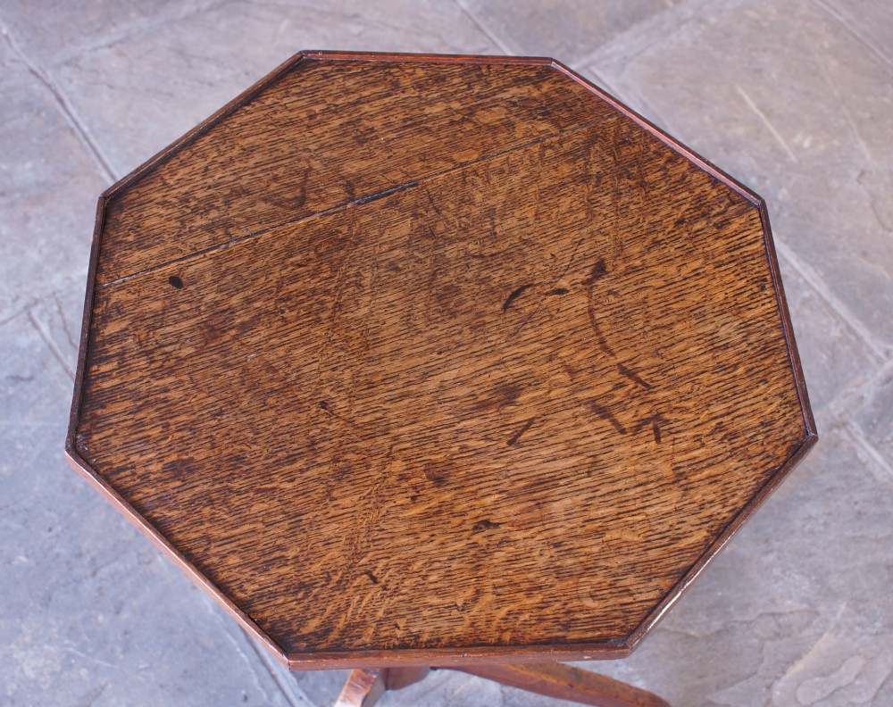 A Georgian oak and elm wine table featuring an octagonal top over a turned pedestal base with three down-swept tripod legs. View III