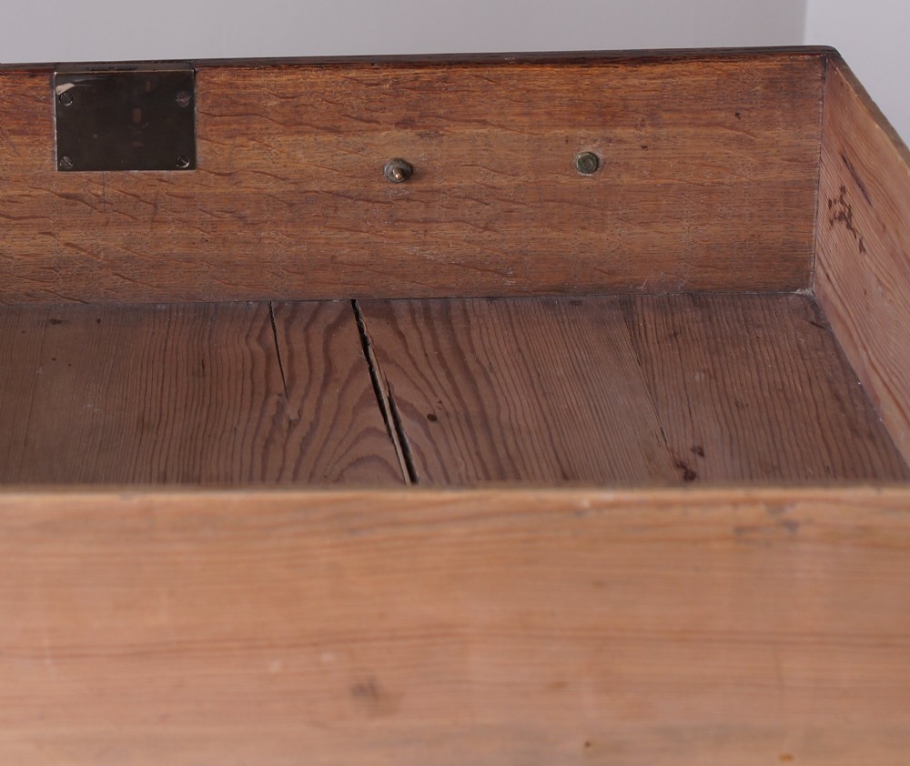 A small Georgian oak chest of drawers featuring four graduated drawers with brass swan-neck handles and bracket feet. View X