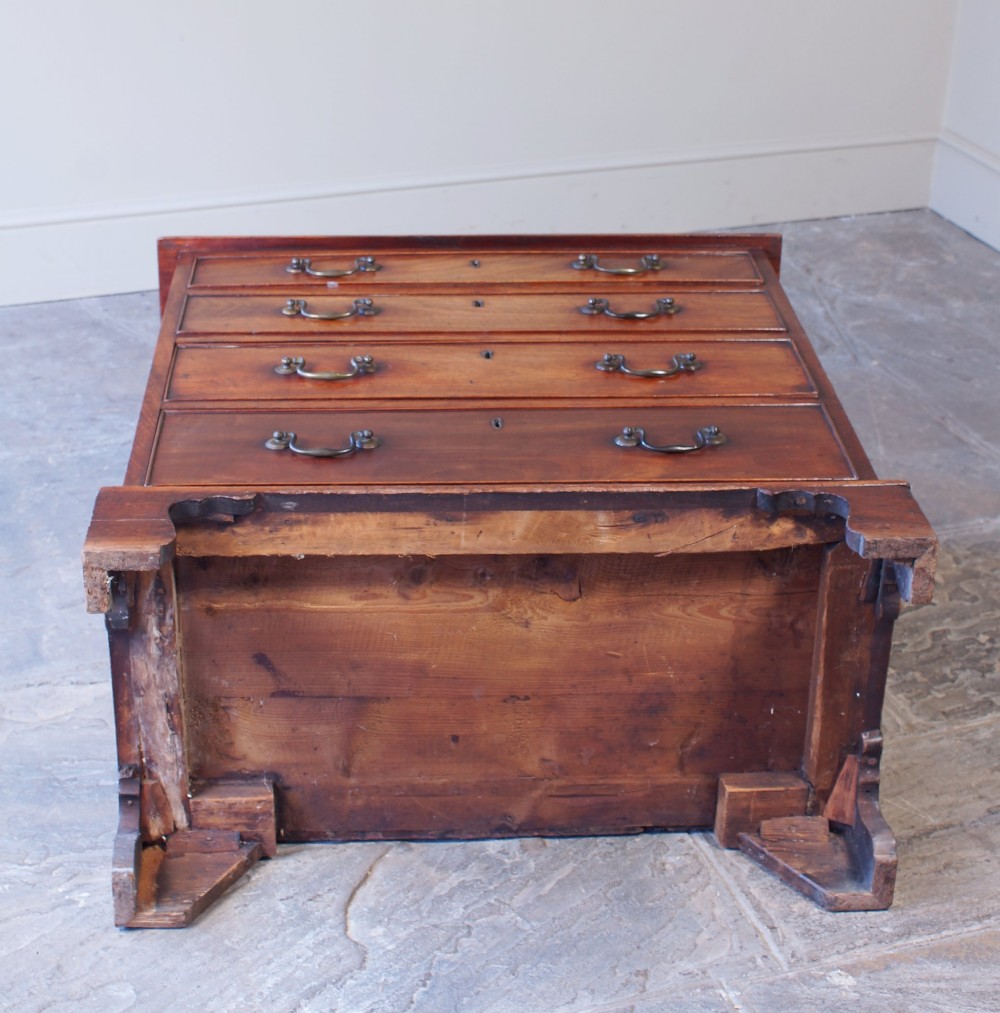 An 18th-century Georgian mahogany chest of drawers featuring four graduated drawers, brass swan-neck handles, keyhole escutcheons, and bracket feet. View V