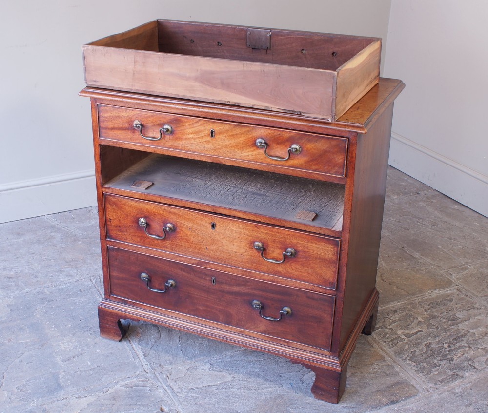 An 18th-century Georgian mahogany chest of drawers featuring four graduated drawers, brass swan-neck handles, keyhole escutcheons, and bracket feet. View IX
