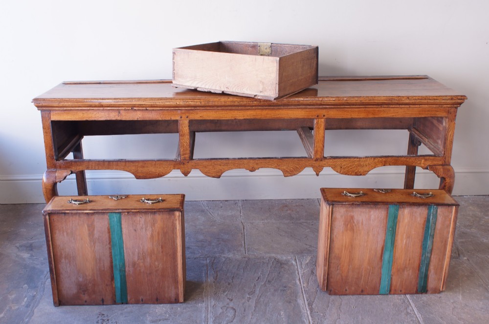 An eighteenth-century oak dresser base featuring three crossbanded drawers with brass handles, a shaped scalloped apron, and slender cabriole legs. View XI