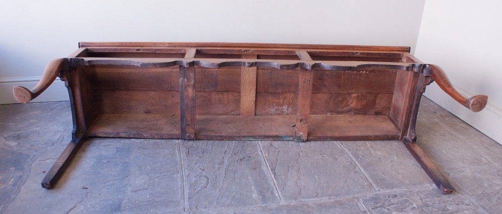 An eighteenth-century oak dresser base featuring three crossbanded drawers with brass handles, a shaped scalloped apron, and slender cabriole legs. View XII
