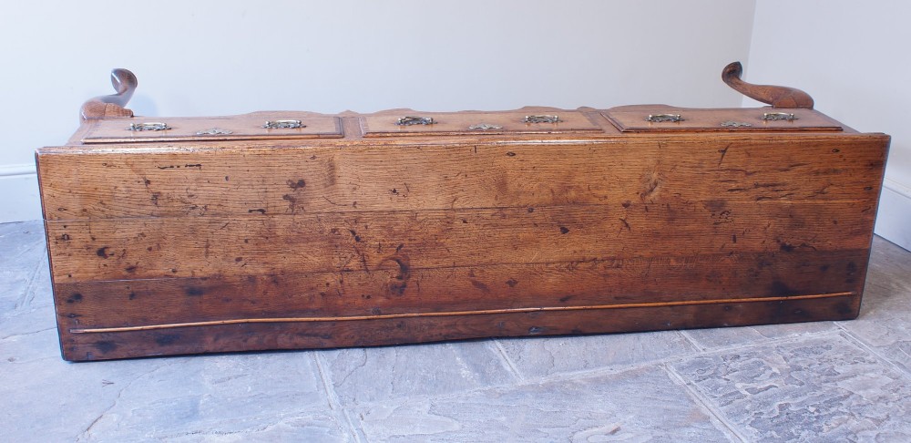 An eighteenth-century oak dresser base featuring three crossbanded drawers with brass handles, a shaped scalloped apron, and slender cabriole legs. View XIII