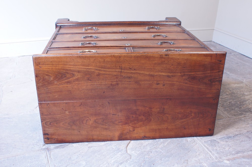 An eighteenth-century fruitwood chest of drawers with two short over three long graduated drawers, brass swan-neck handles, keyhole escutcheons, and shaped bracket feet. View VIII