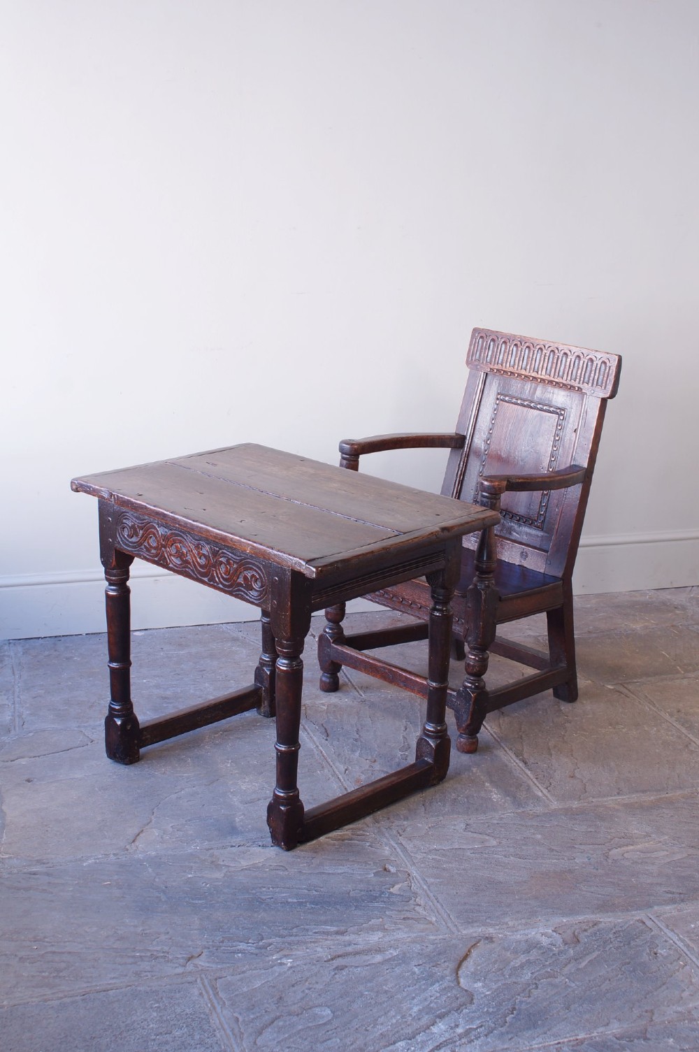 A dark brown 17th-century oak childs wainscot armchair with carved geometric back panels and turned supports. View XII