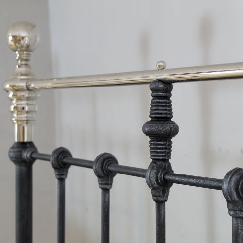 fig 2. A pair of single metal platform beds featuring dark charcoal vertical spindles and polished nickel top rails with spherical finials.