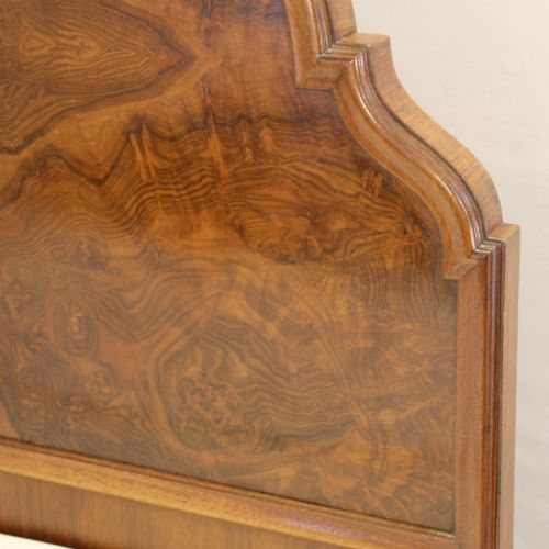 fig 1. A matching pair of Queen Anne style bed frames crafted from warm brown burr walnut with arched headboards and cabriole legs.
