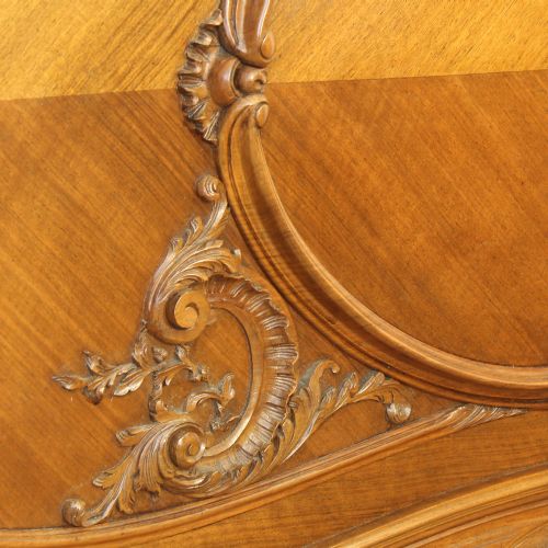 fig 1. A carved walnut double bed frame featuring an arched headboard and footboard with book-matched veneers and Rococo cresting.