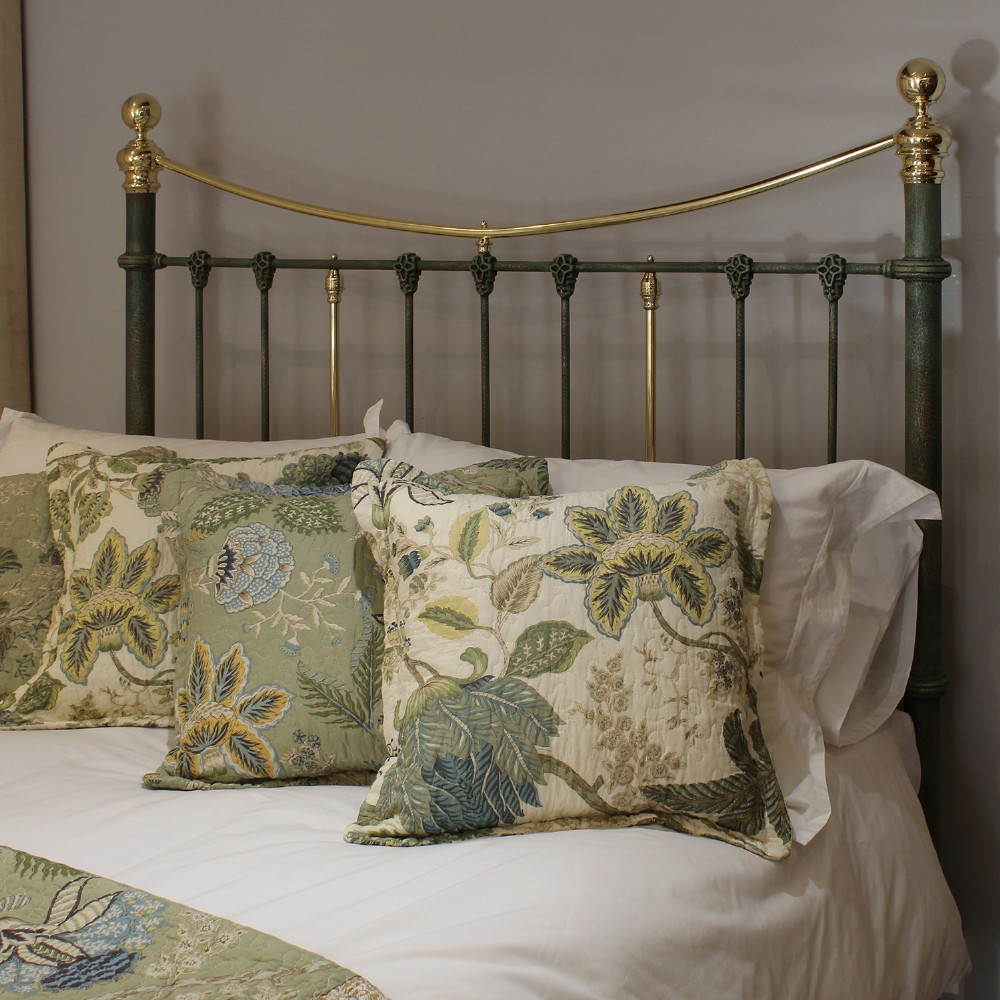A king-size green painted metal bedstead featuring curved brass top rails, polished brass finials, and vertical central spindles. View IV