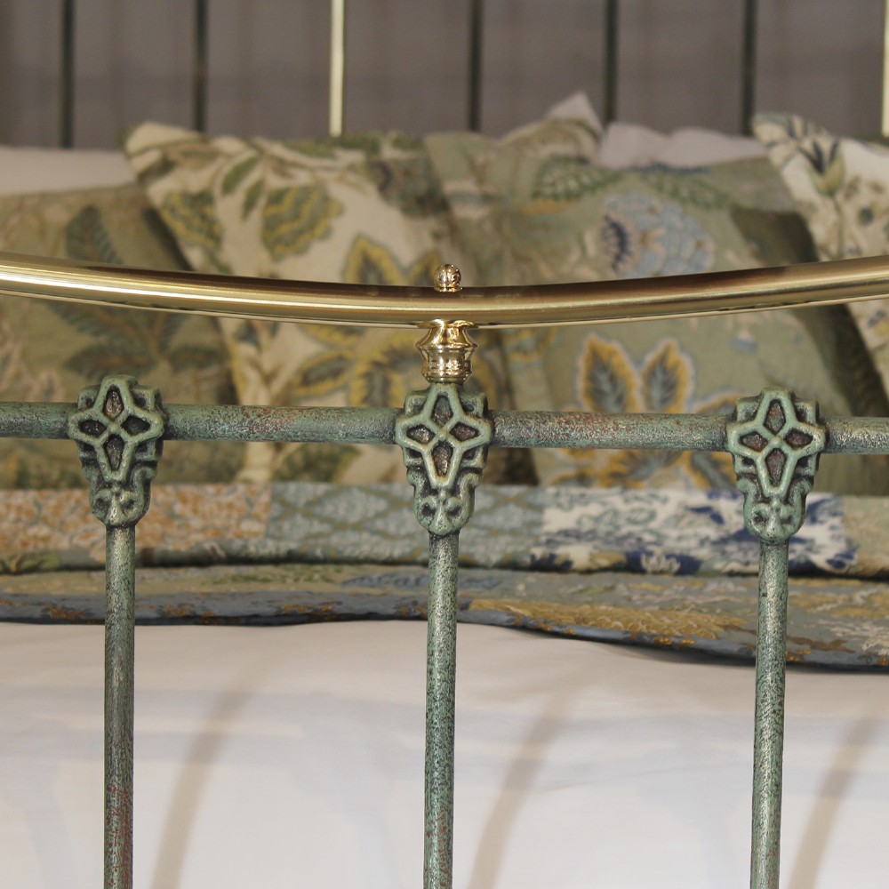 A king-size green painted metal bedstead featuring curved brass top rails, polished brass finials, and vertical central spindles. View VII