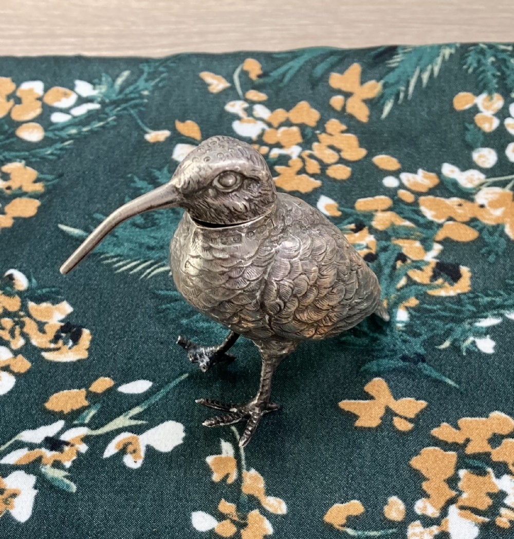 A Victorian sterling silver pepper pot finely cast in the shape of a snipe bird with detailed feathered texturing and a long beak.