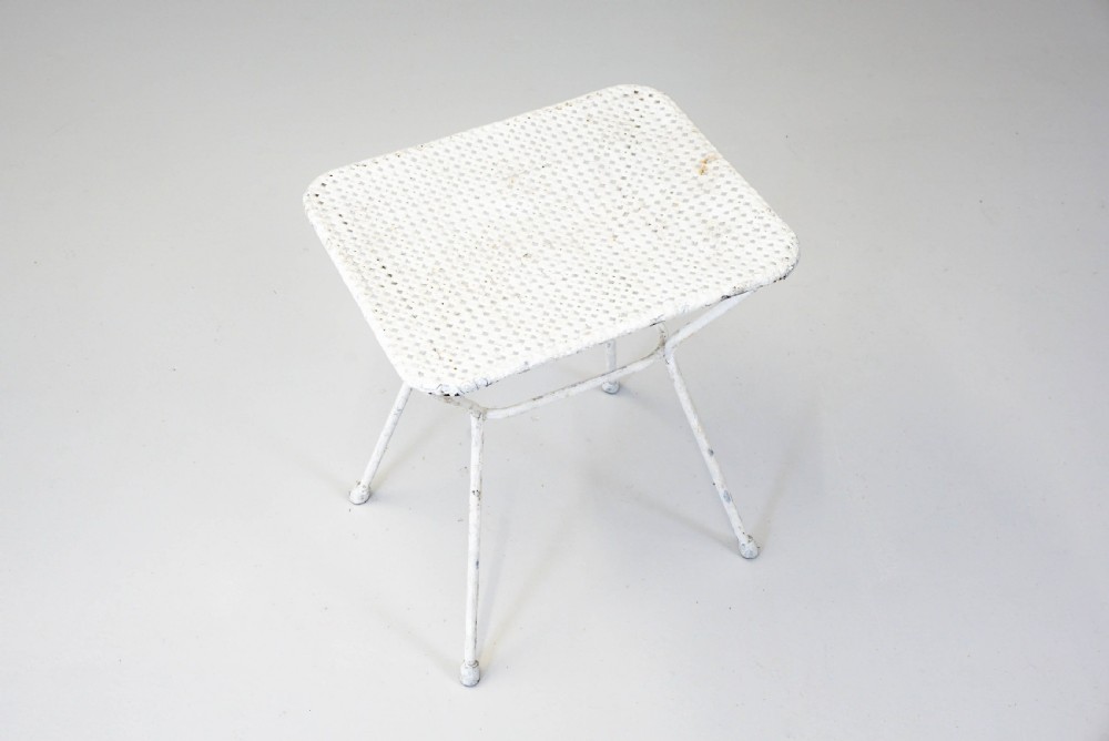 A pair of mid-century white painted metal side tables with perforated mesh rectangular tops and splayed tubular legs connected by a central circular ring. View III